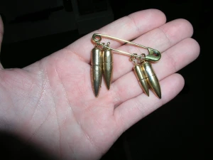 TFP member holds the four bullets that nearly took the life of Colonel Ripley. 